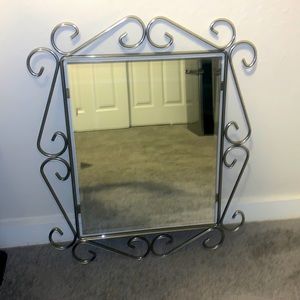 Silver mirror , has some weight so when hung you’ll need nails/something sturdy!